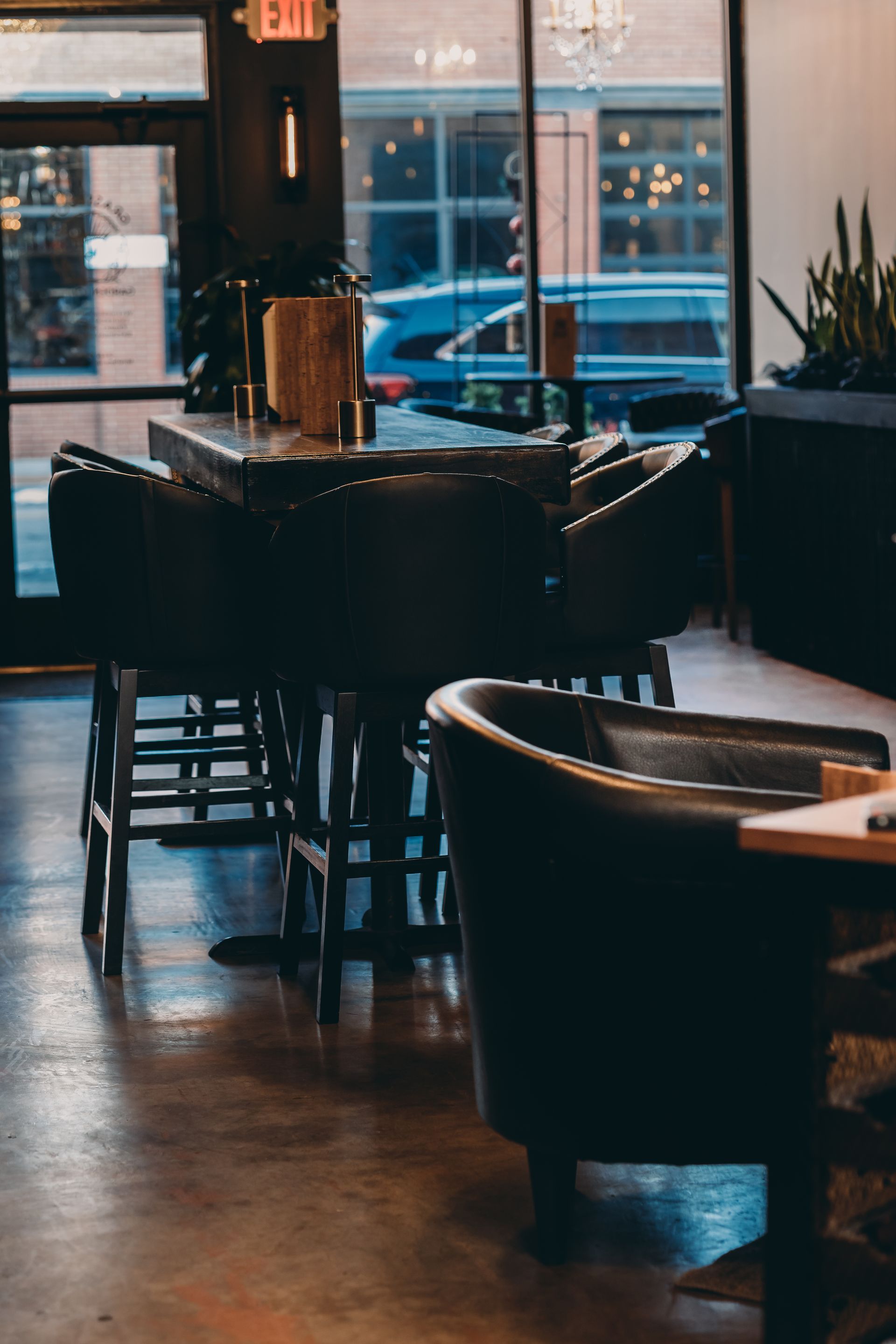 A restaurant with tables and chairs and a large window.