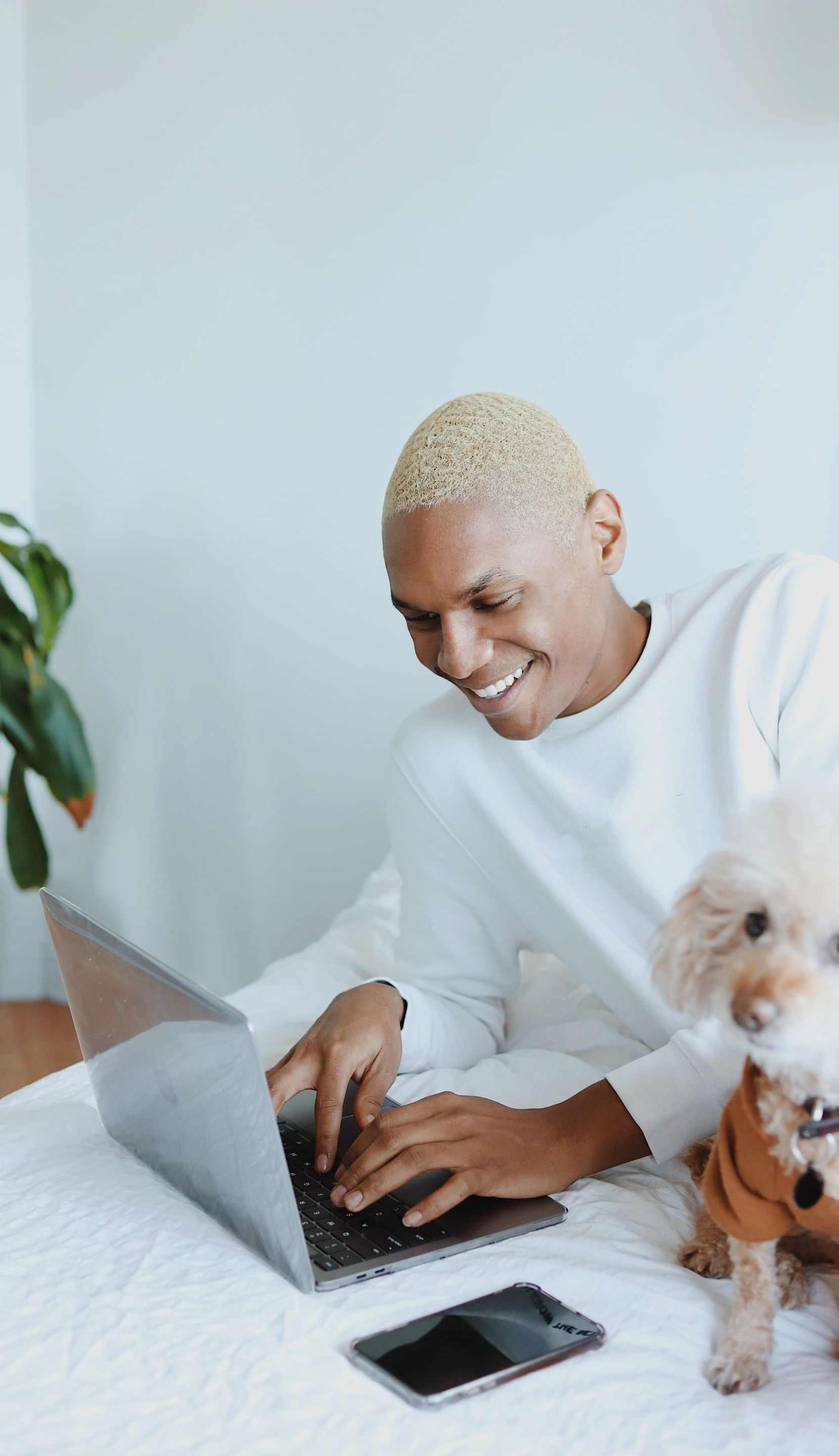 man on laptop with dog