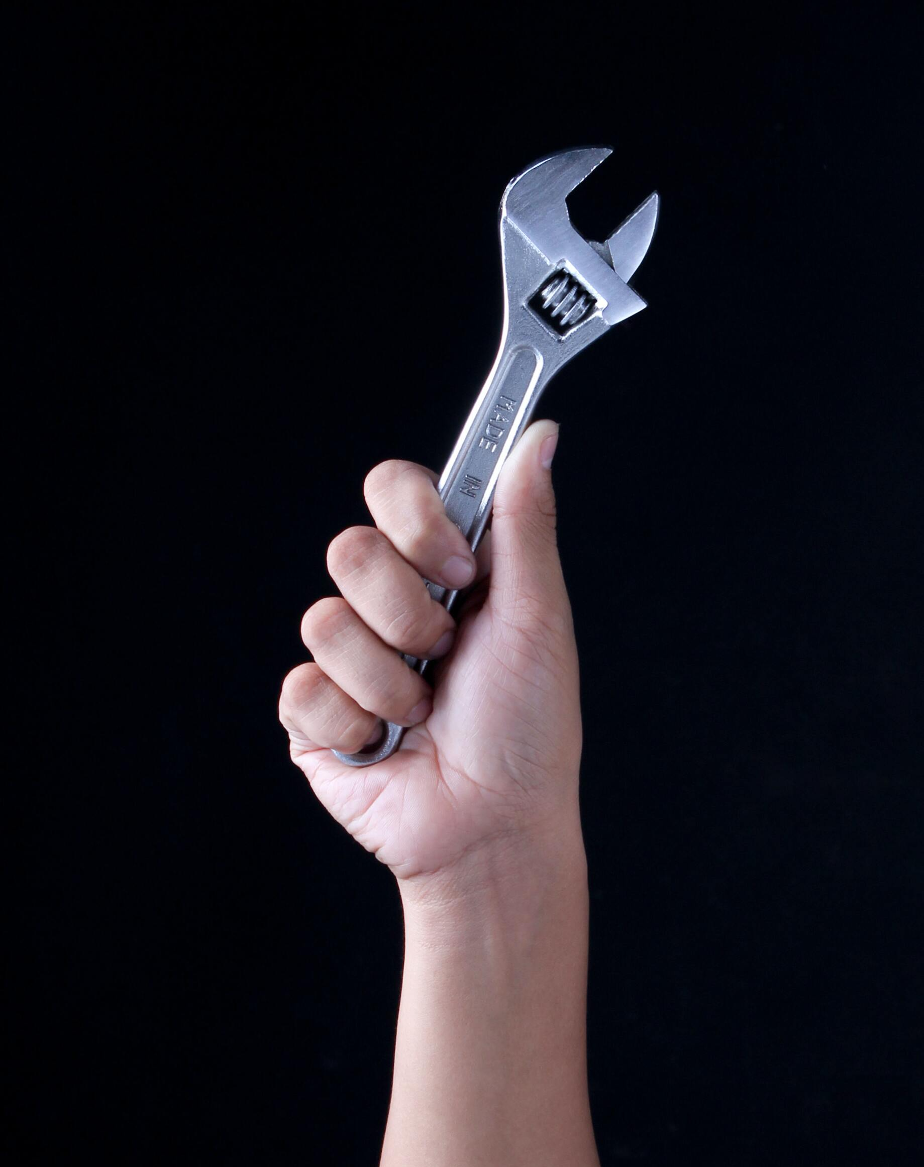 hand holding a wrench