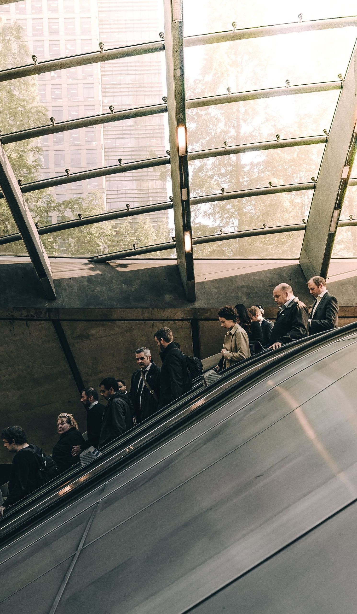 business people on an escalator