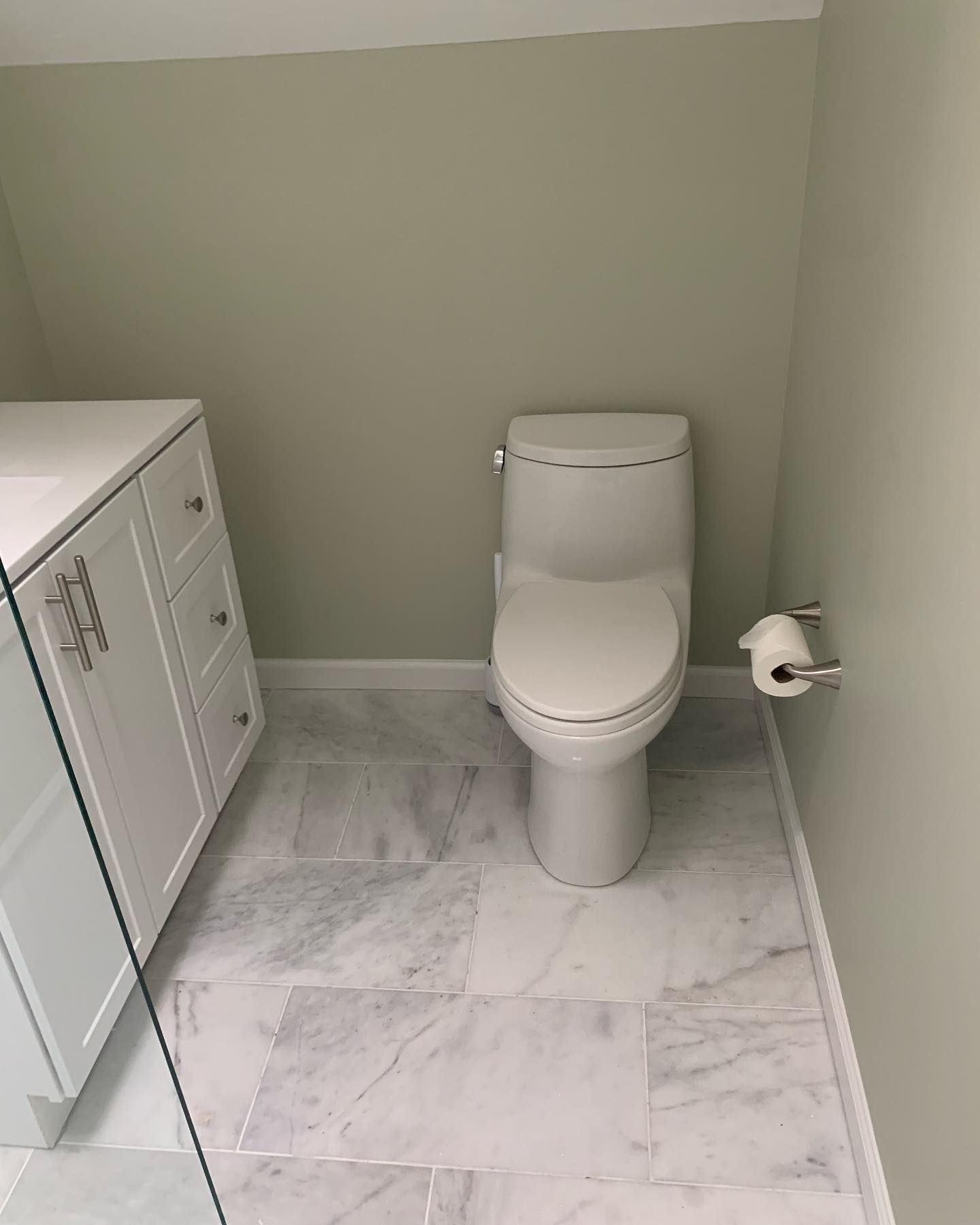A bathroom with a walk in shower and a sink.