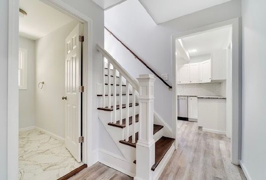 A kitchen with stainless steel appliances and granite counter tops.