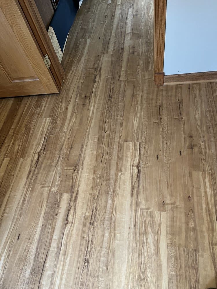 A close up of a wooden floor in a hallway.