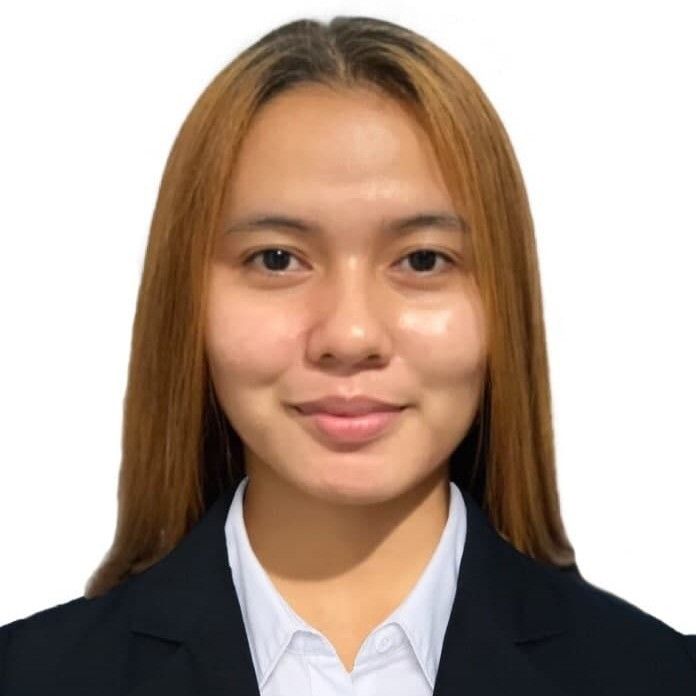 A woman in a suit and white shirt is smiling for the camera