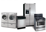 Set of stainless steel home appliances: washer and dryer, dishwasher, refrigerator, and oven.