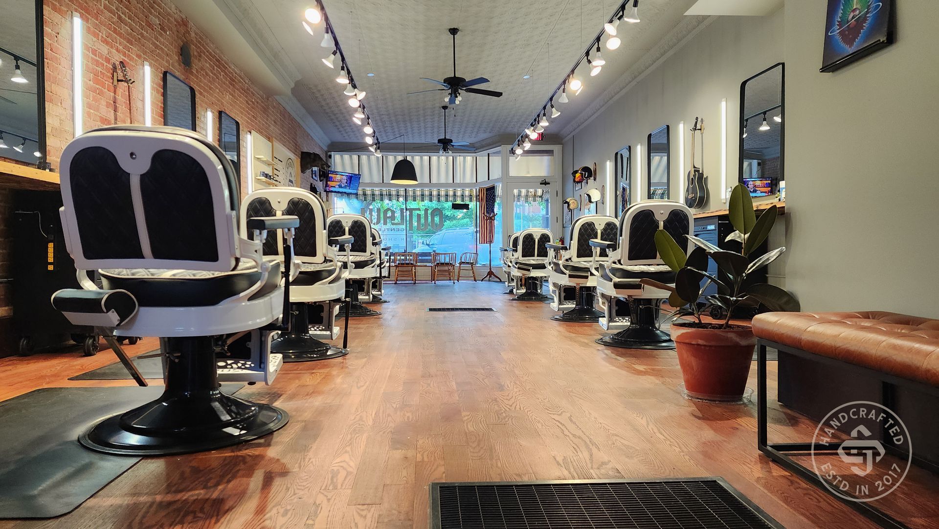 A barber shop with a lot of chairs and mirrors.