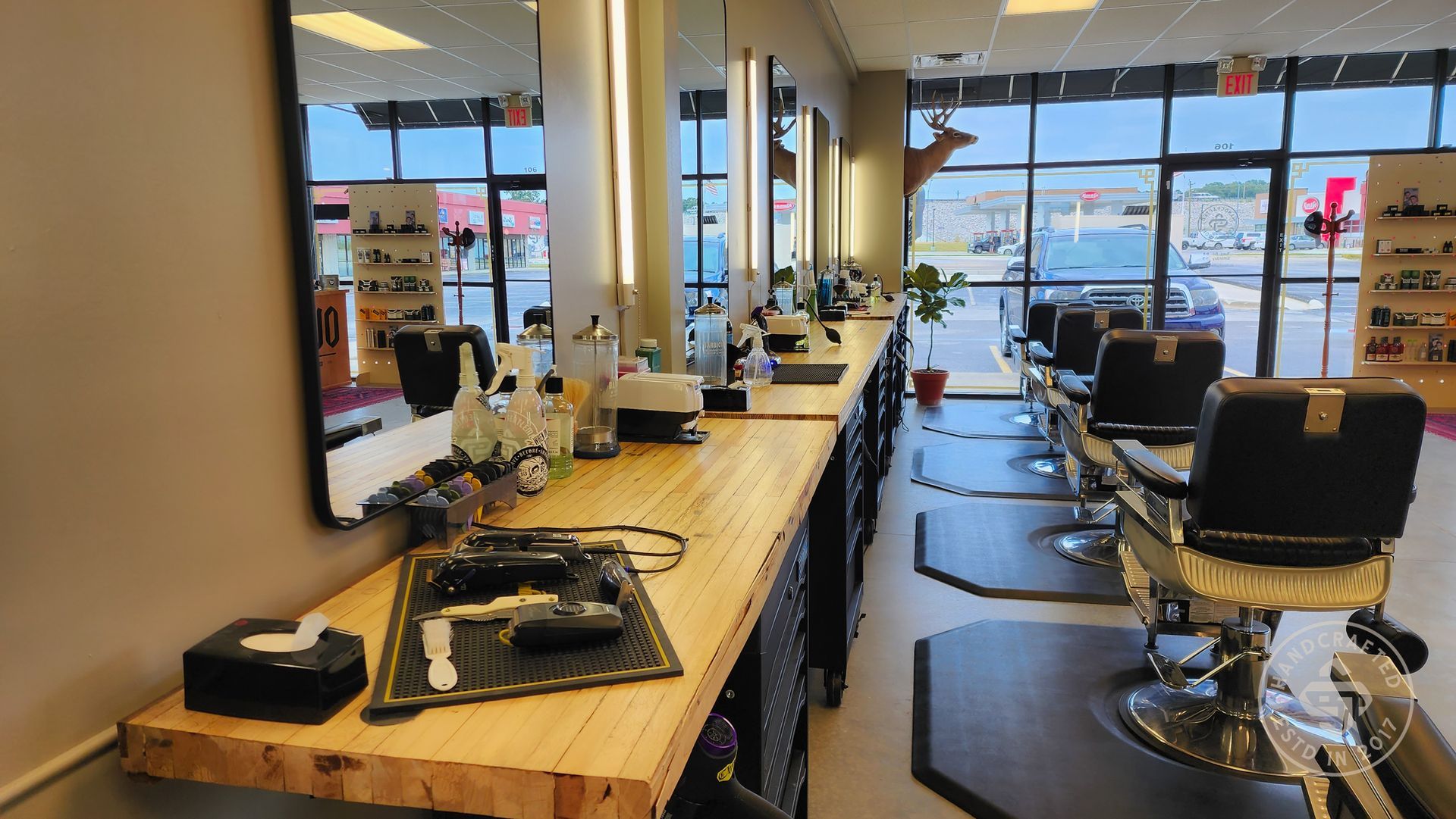 A barber shop with a lot of chairs and mirrors.