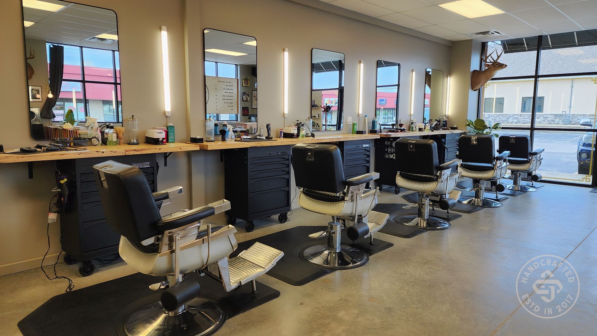A barber shop with a lot of chairs and mirrors.