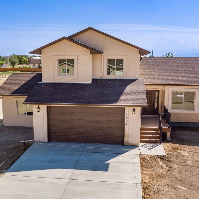 An aerial view of a house with a brown garage door