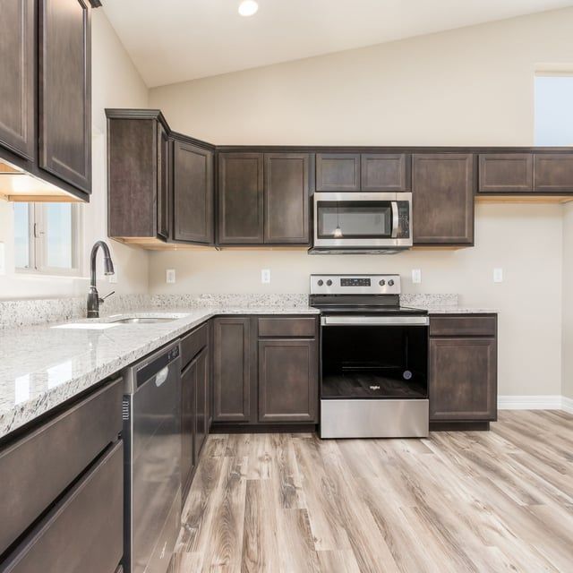 A kitchen with stainless steel appliances and wooden cabinets