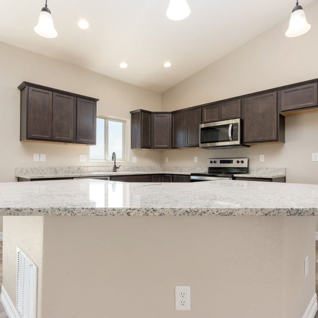 A kitchen with granite counter tops and stainless steel appliances