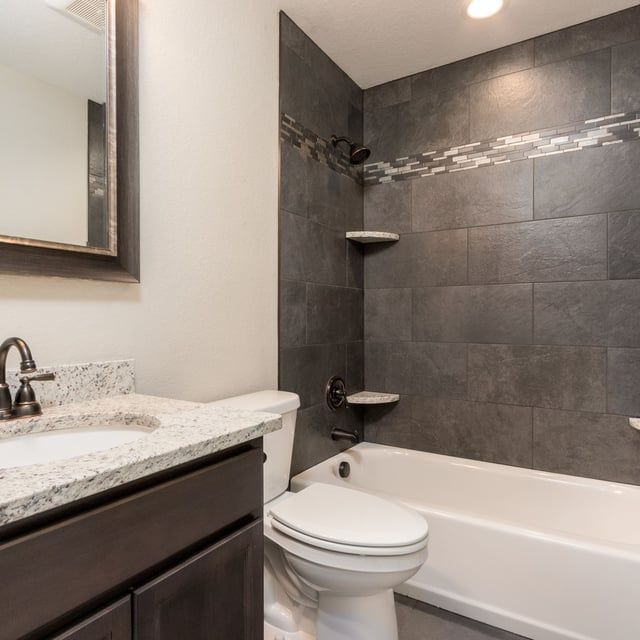 A bathroom with a toilet a sink and a bathtub