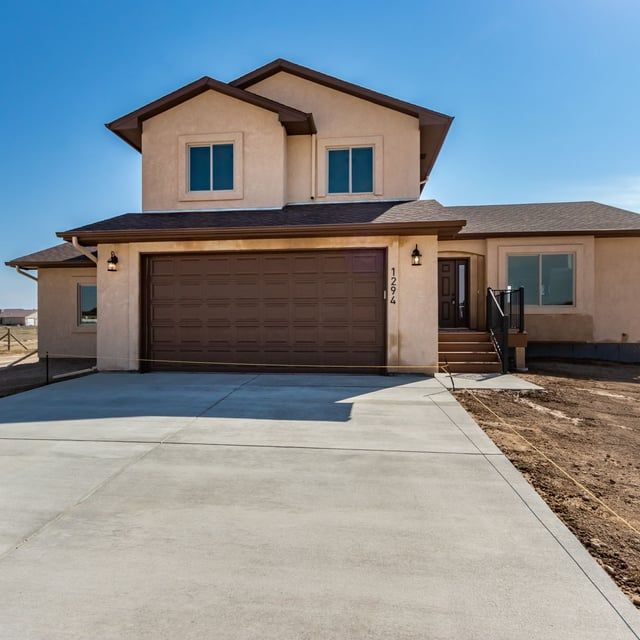 A house with a brown garage door and a concrete driveway