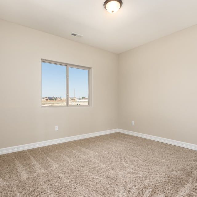 An empty bedroom with a window and a ceiling fan.