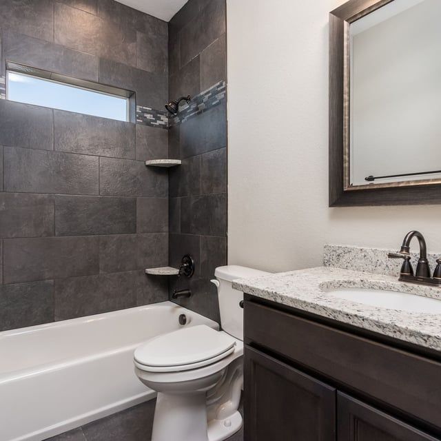 A bathroom with a toilet a sink and a bathtub