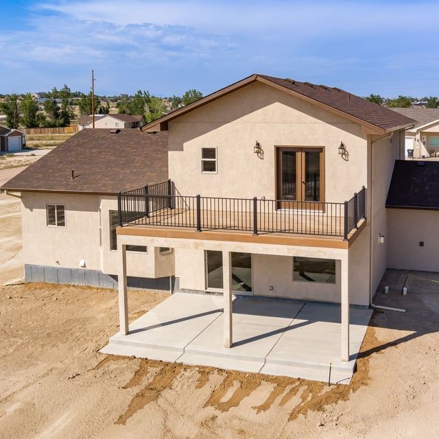 An aerial view of a house with the word home written in the dirt