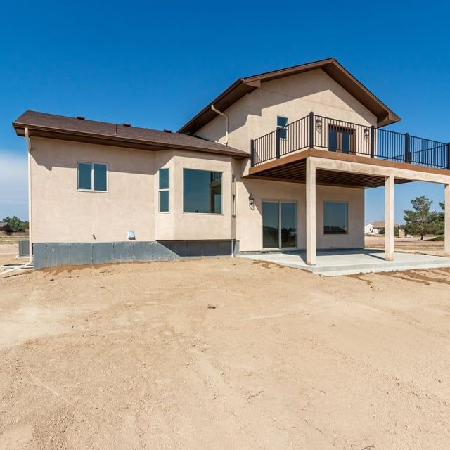 A large house with a balcony on top of it