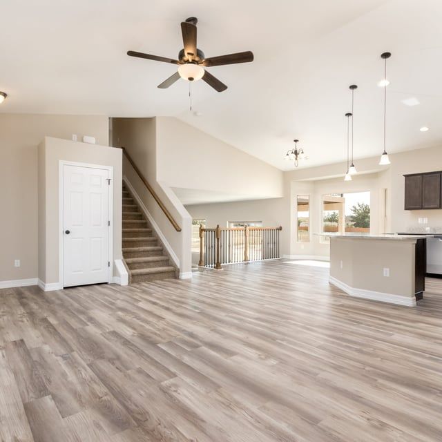 A living room with hardwood floors and a ceiling fan