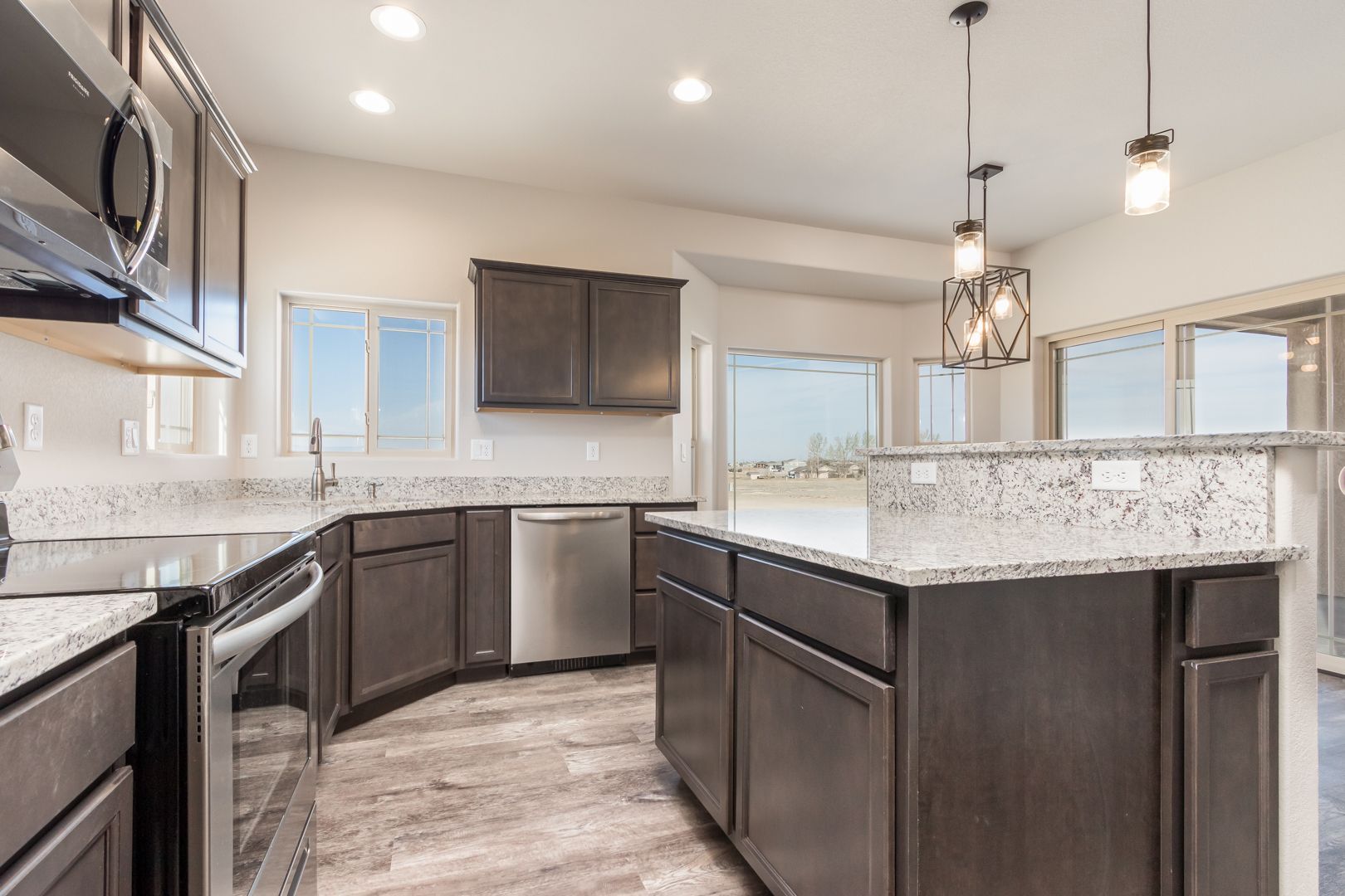 A kitchen with stainless steel appliances and granite counter tops.