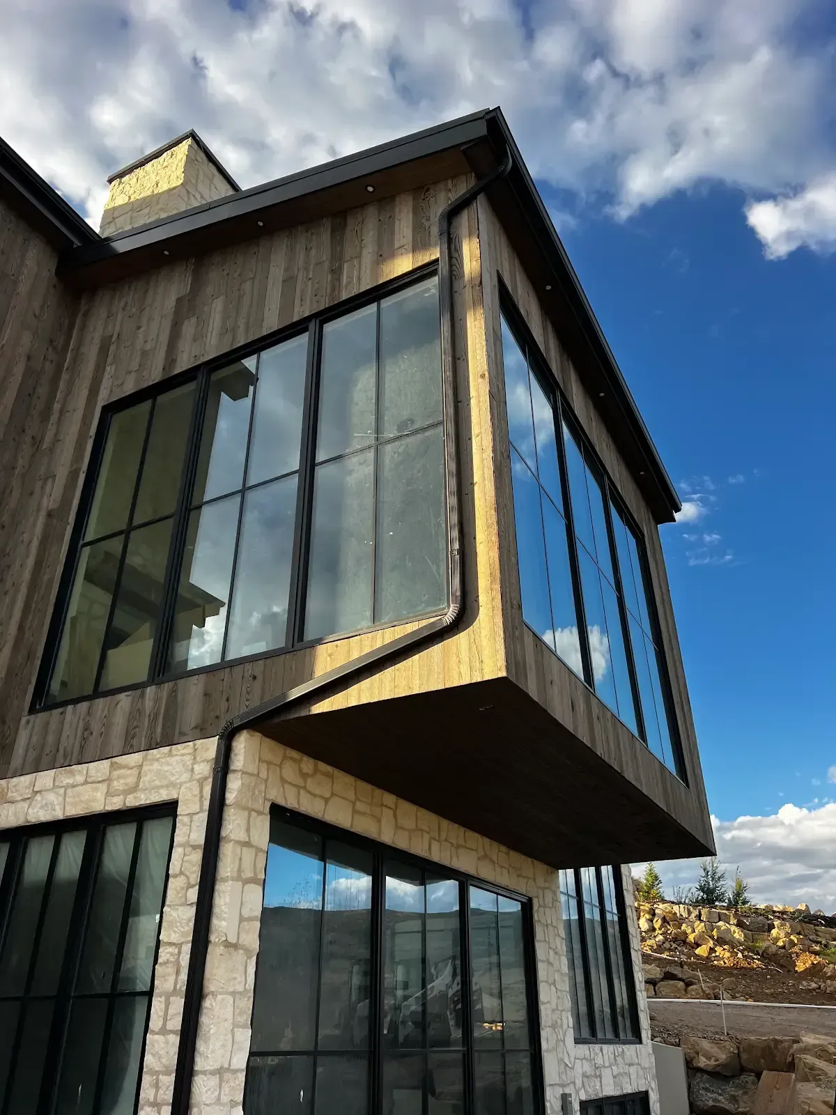 A house with a lot of windows and a blue sky in the background