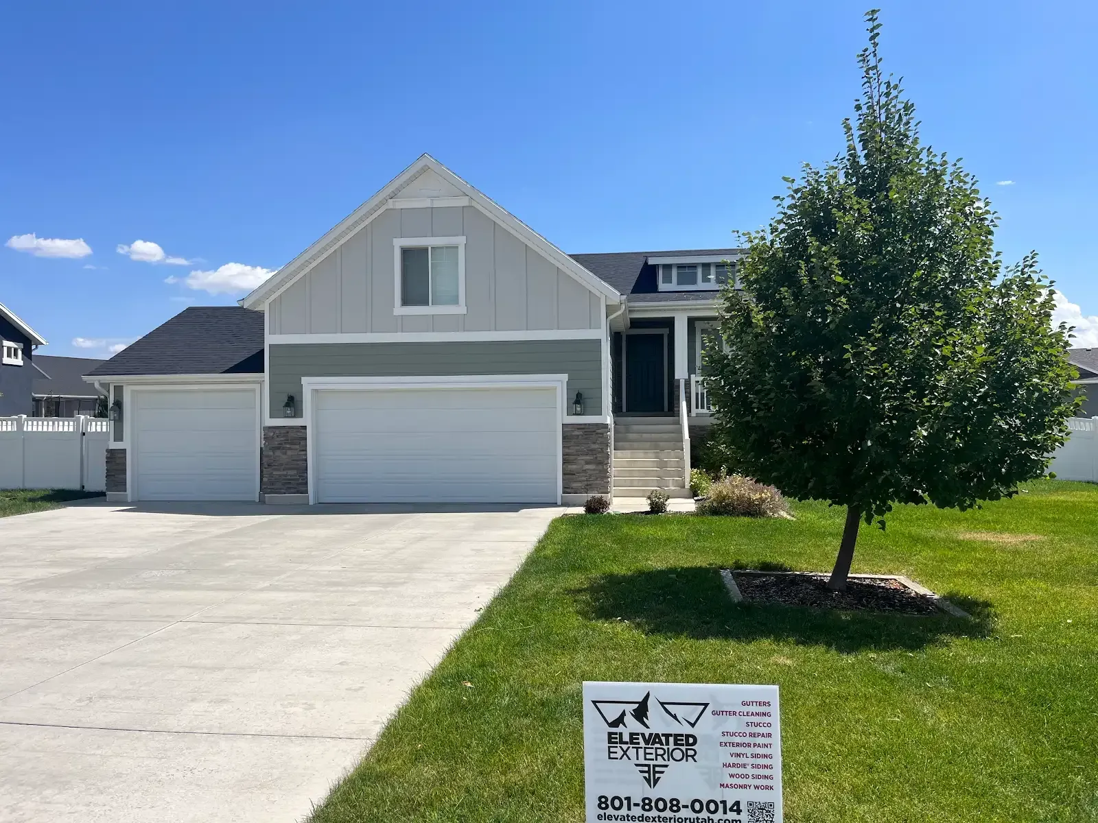 A house for sale with a sign in front of it.