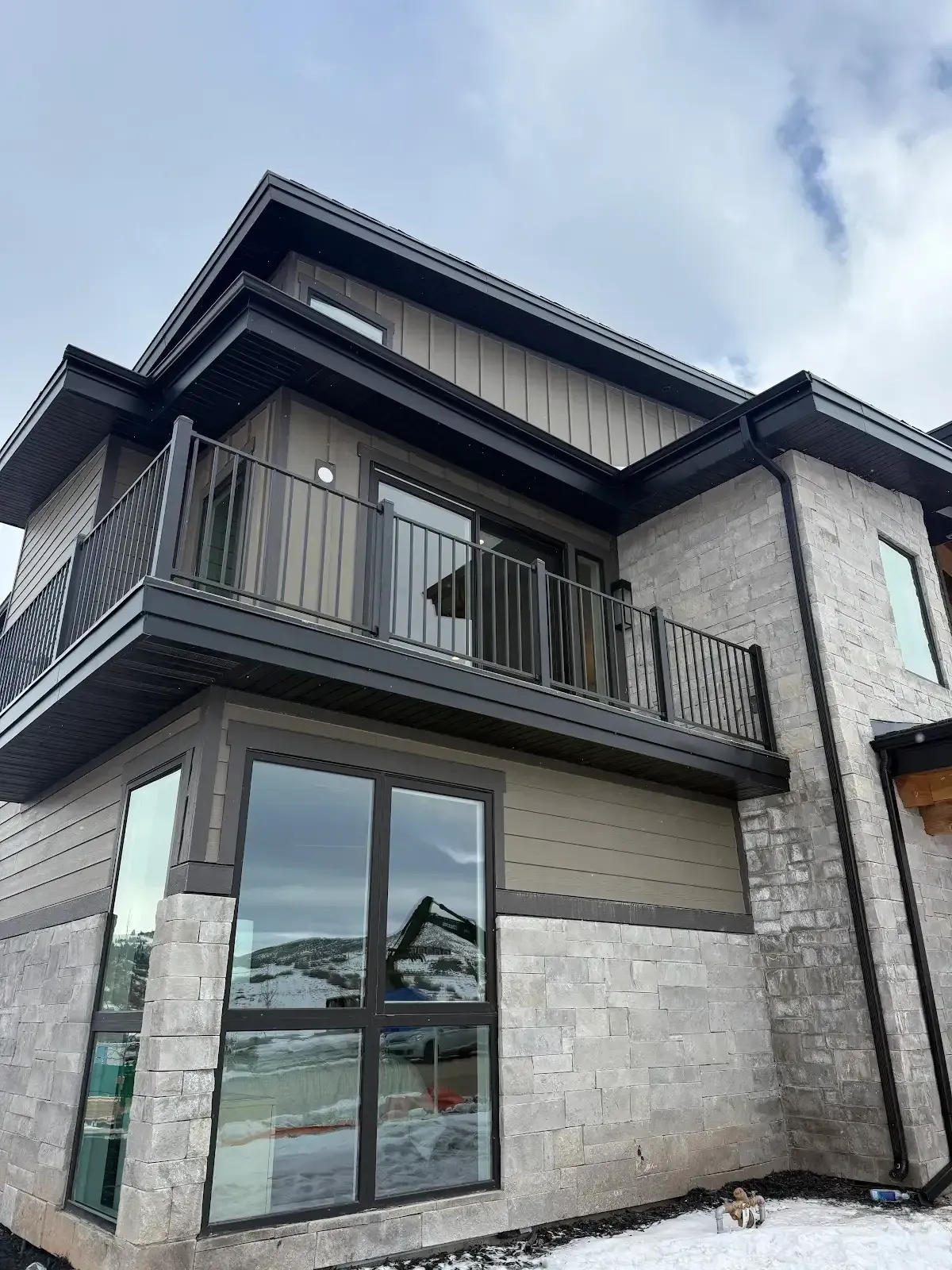 A large house with a balcony and a lot of windows.