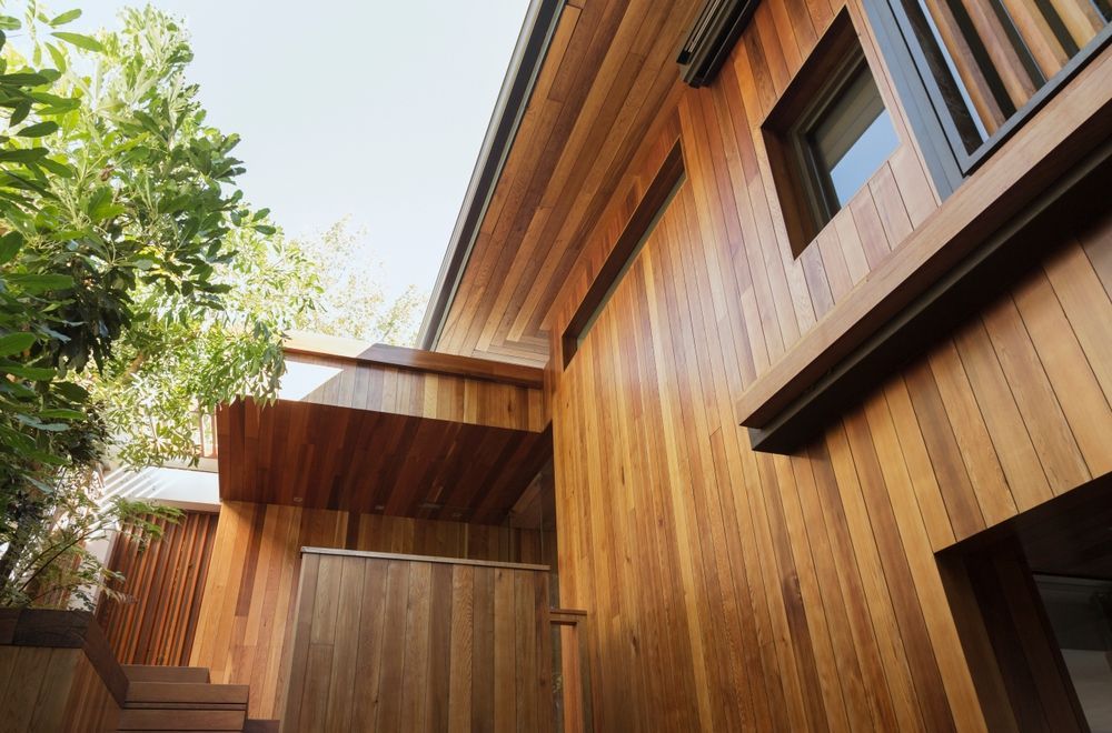 A wooden house with a balcony and stairs