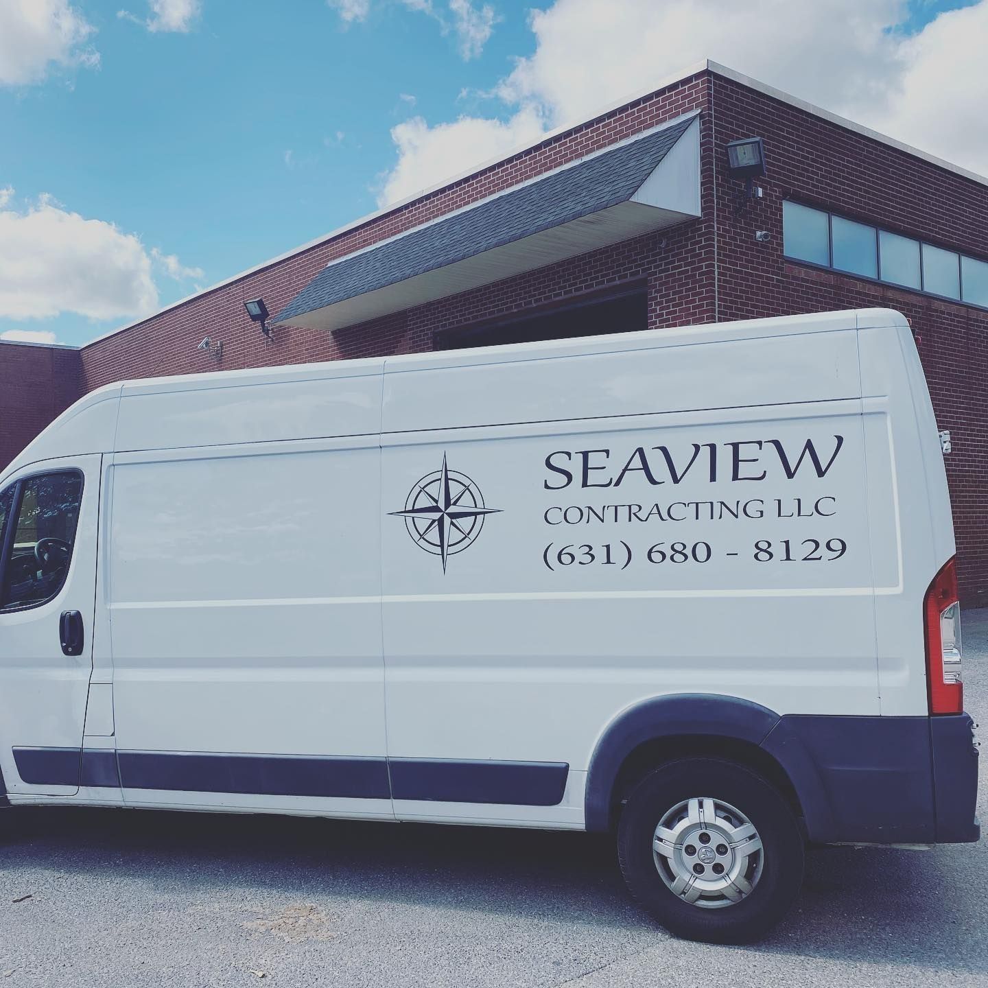 White Seaview Contracting van parked in front of a brick building; logo and phone number visible.