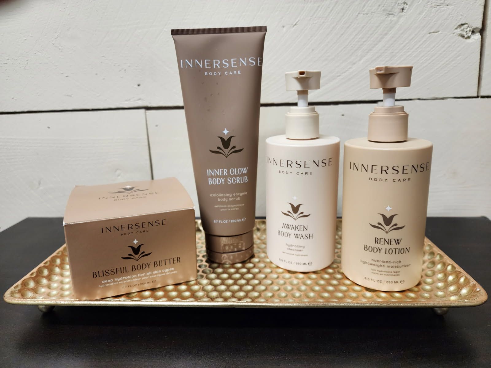 Four bottles of innersense are on a gold tray
