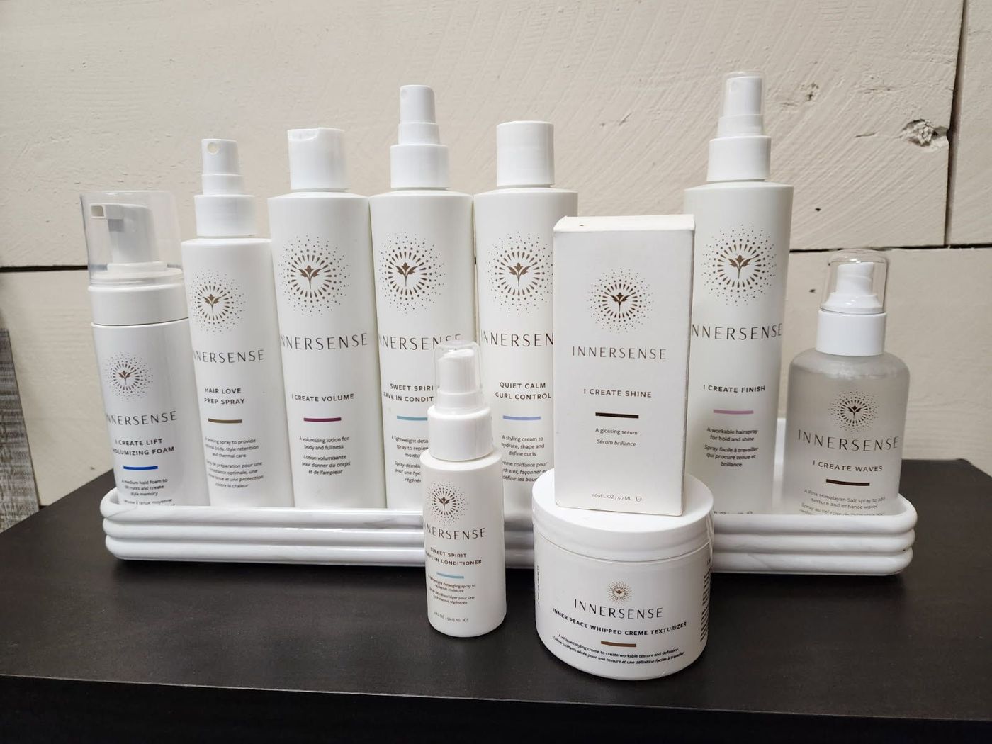 A bunch of white bottles and containers on a table