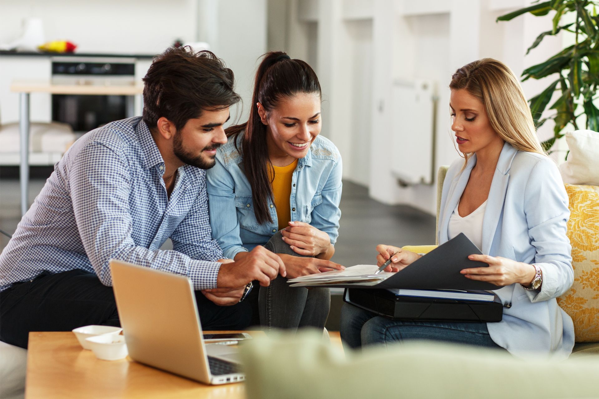 Happy Couple Talking a Female Agent