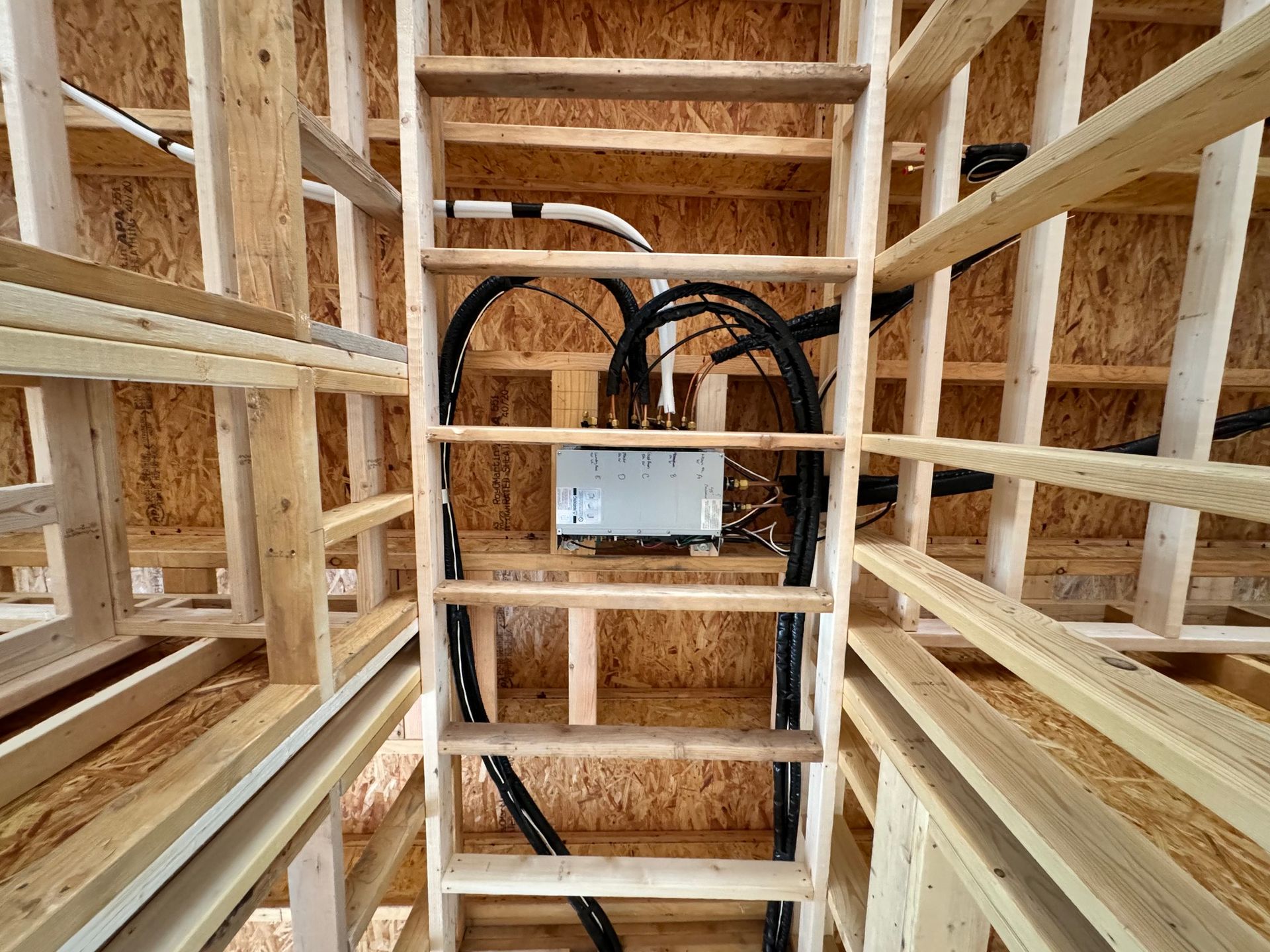 A ladder is hanging from the ceiling of a building under construction.