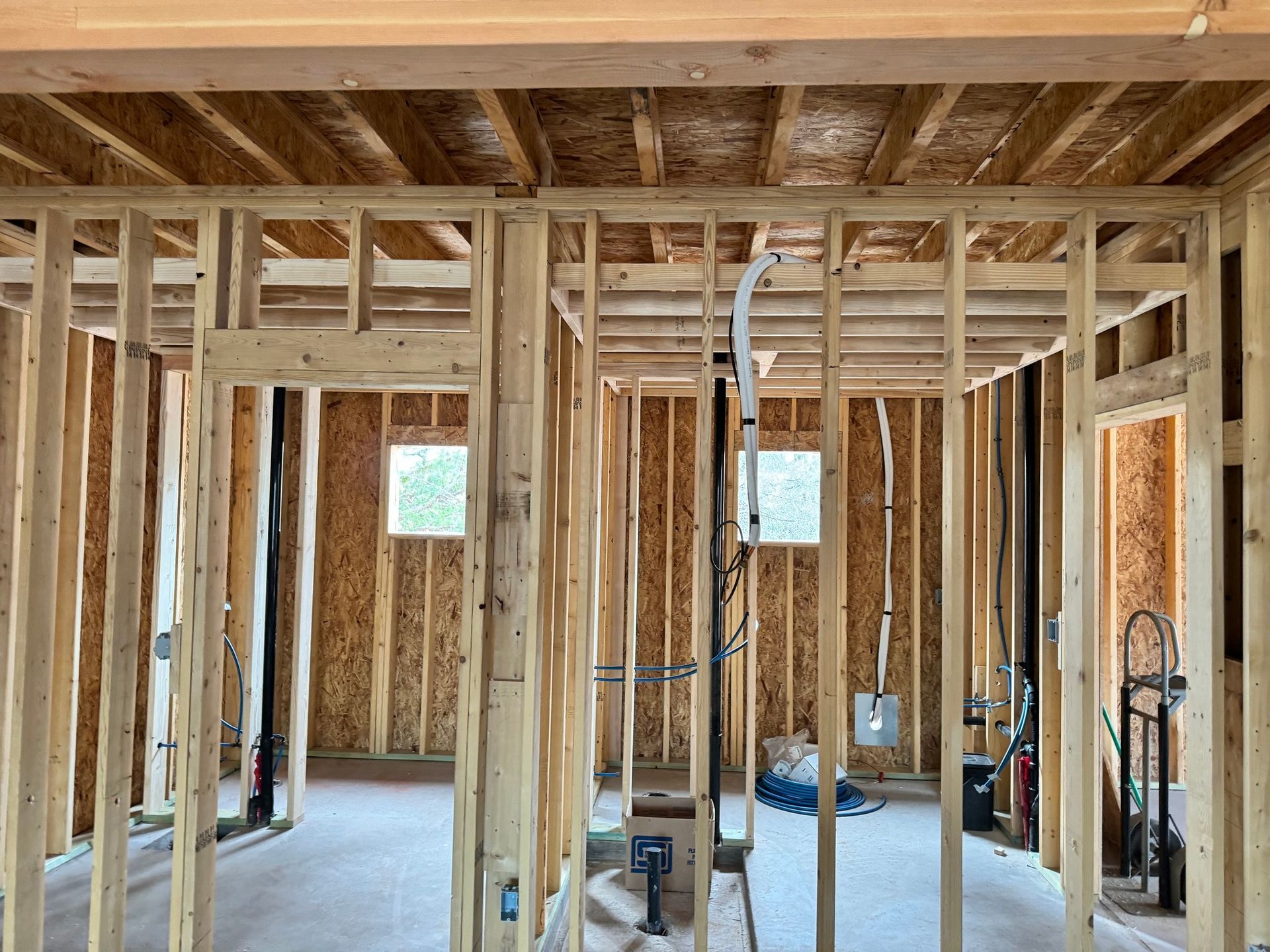 The inside of a house under construction with wooden beams.