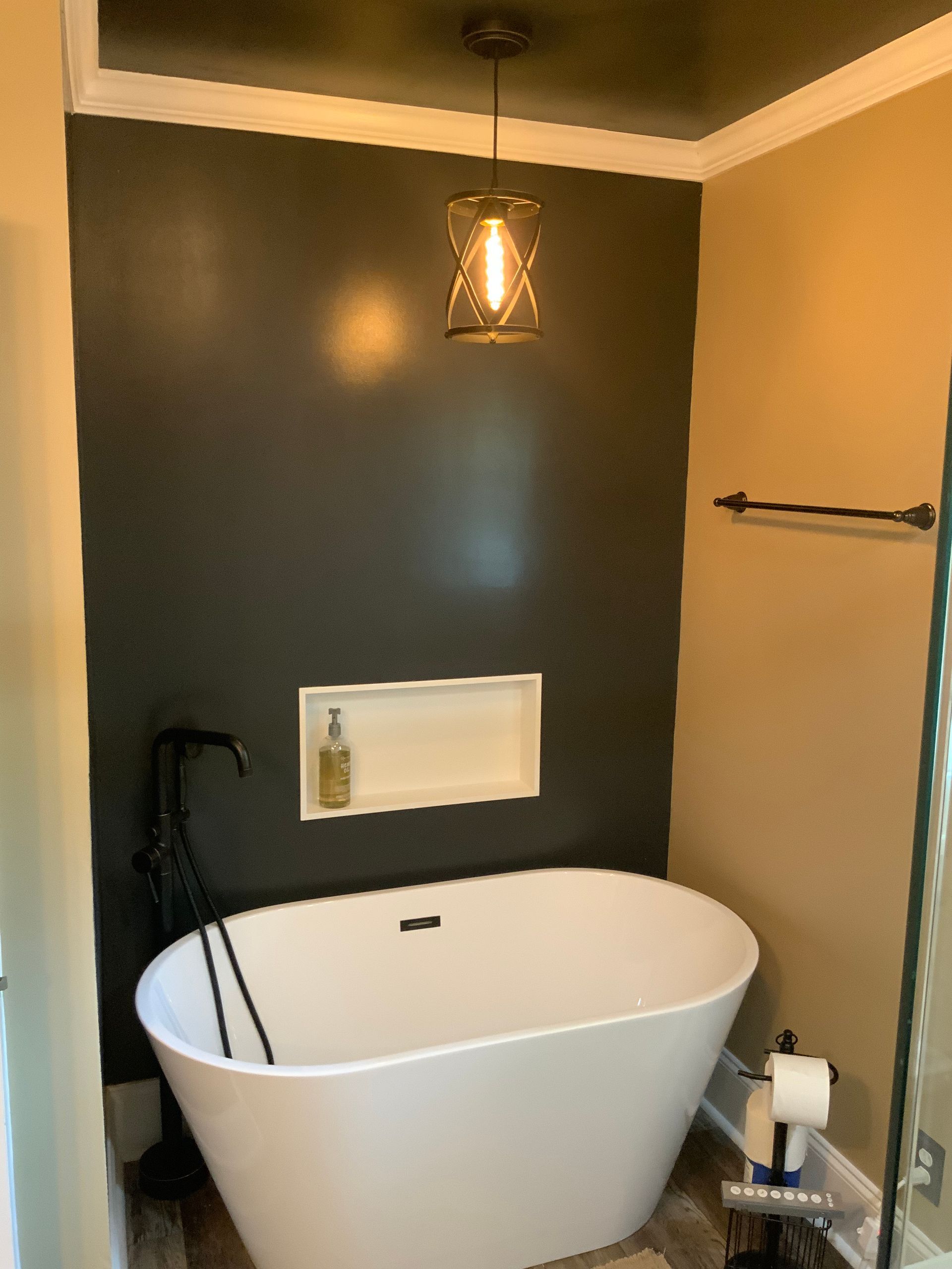 A bathroom with a walk in shower , sink , toilet and mirror.