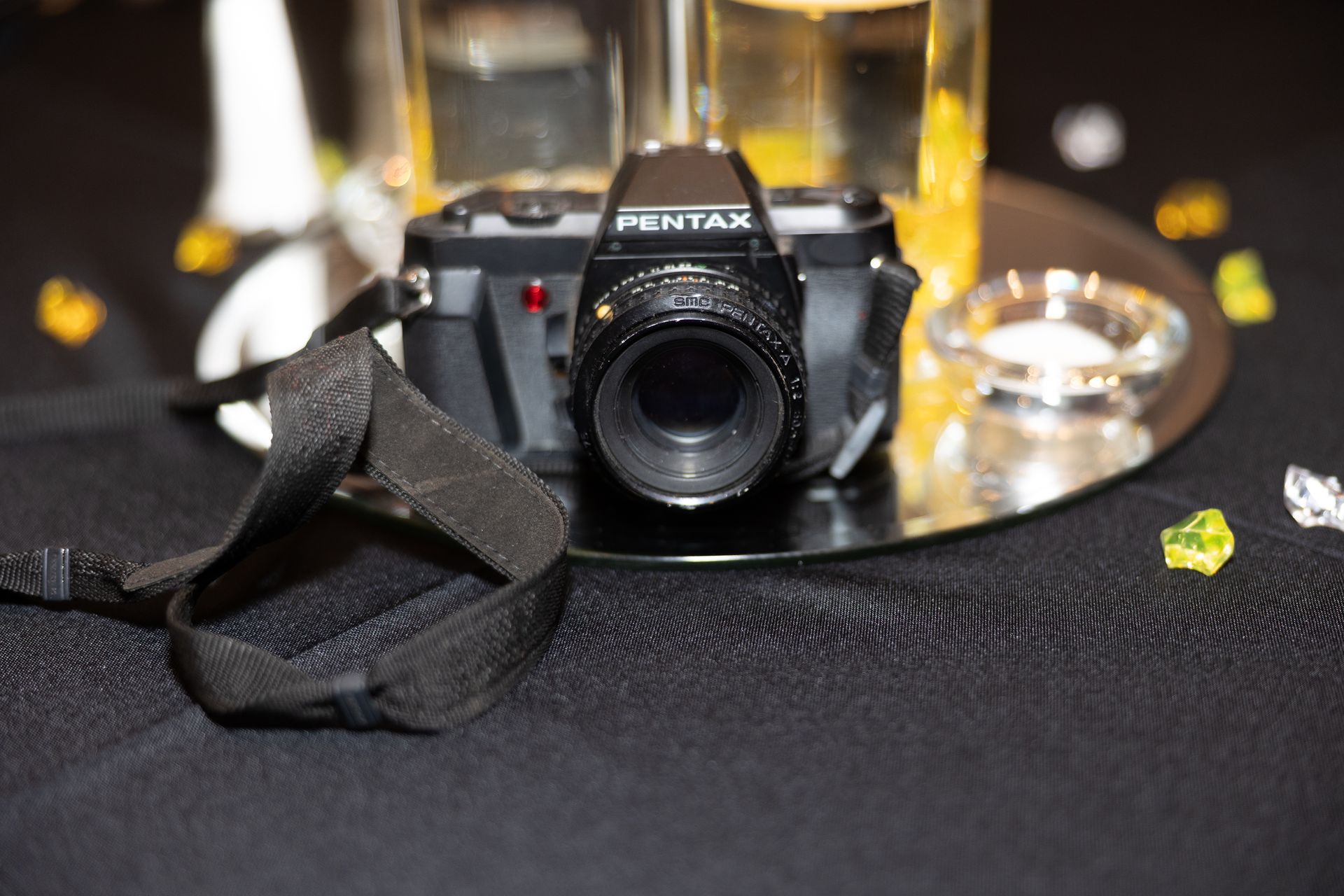 A pentax camera is sitting on a table