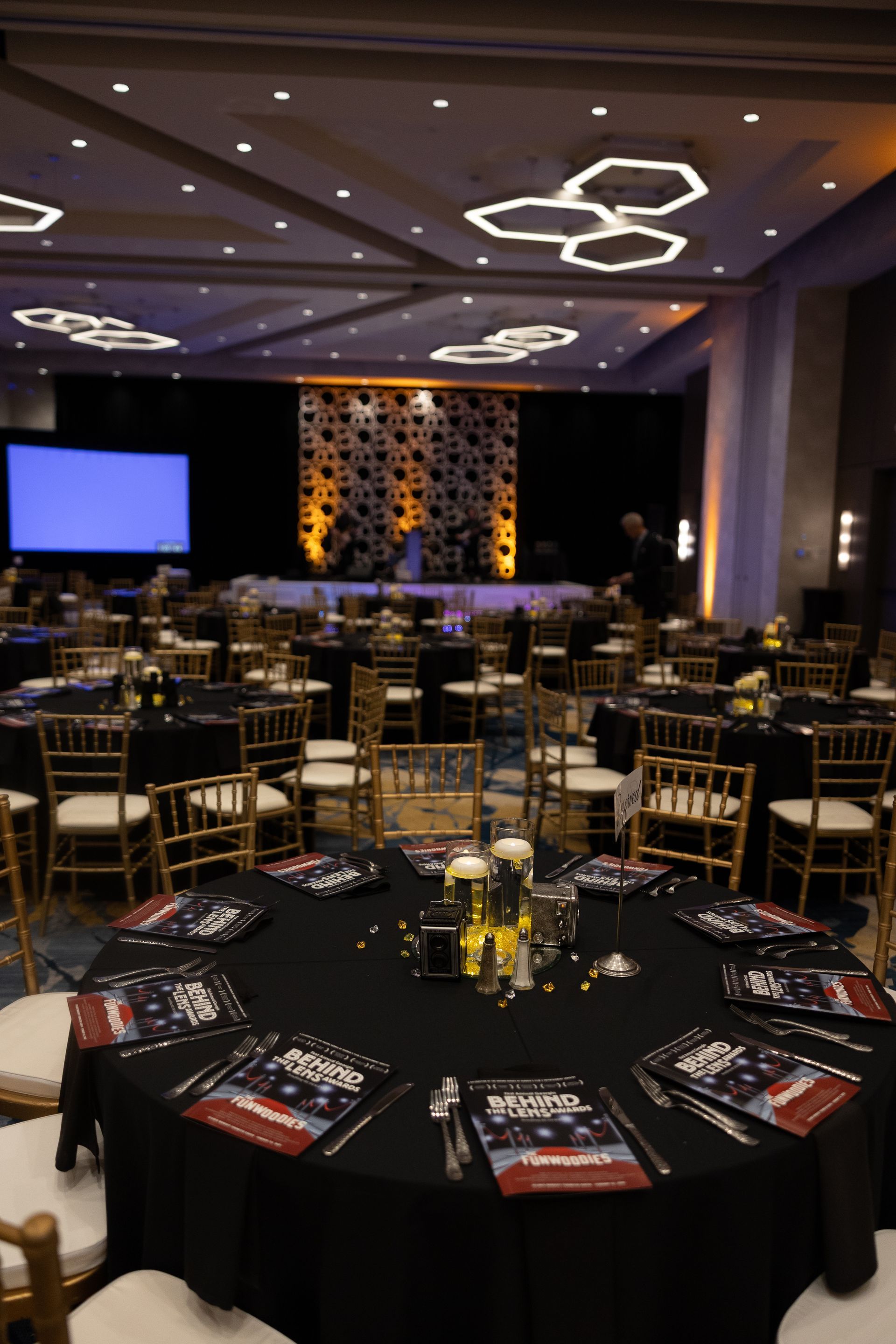 A large room with tables and chairs set up for a banquet