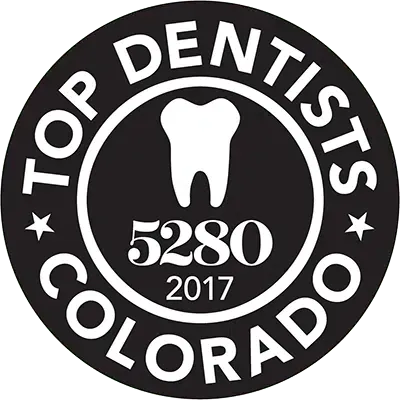 Top Dentist Colorado 2017 award seal: white tooth inside a black circle with text.