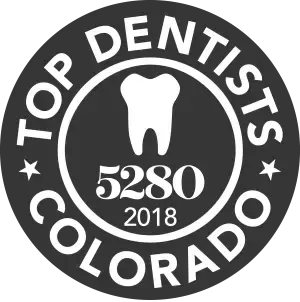 Top Dentist Colorado 2018 badge, white tooth icon on a black background, text