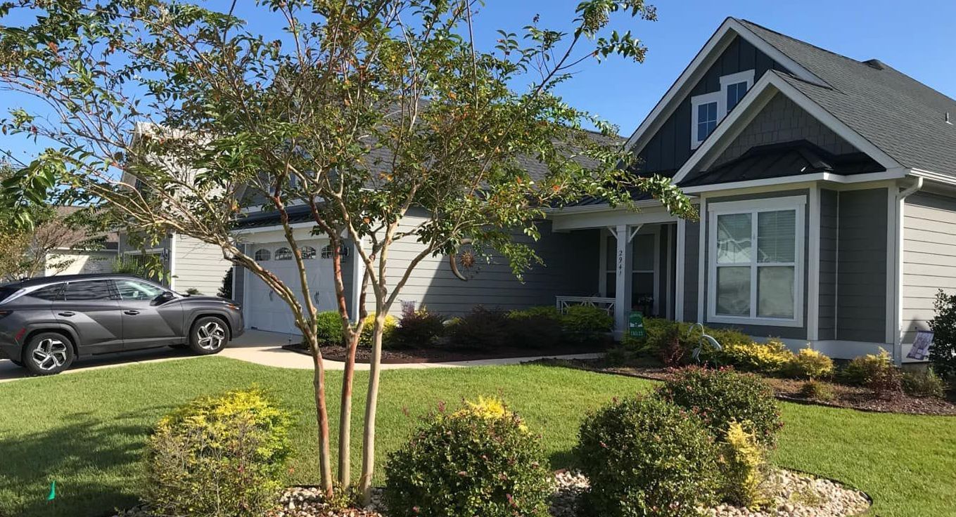 A house with a car parked in front of it.