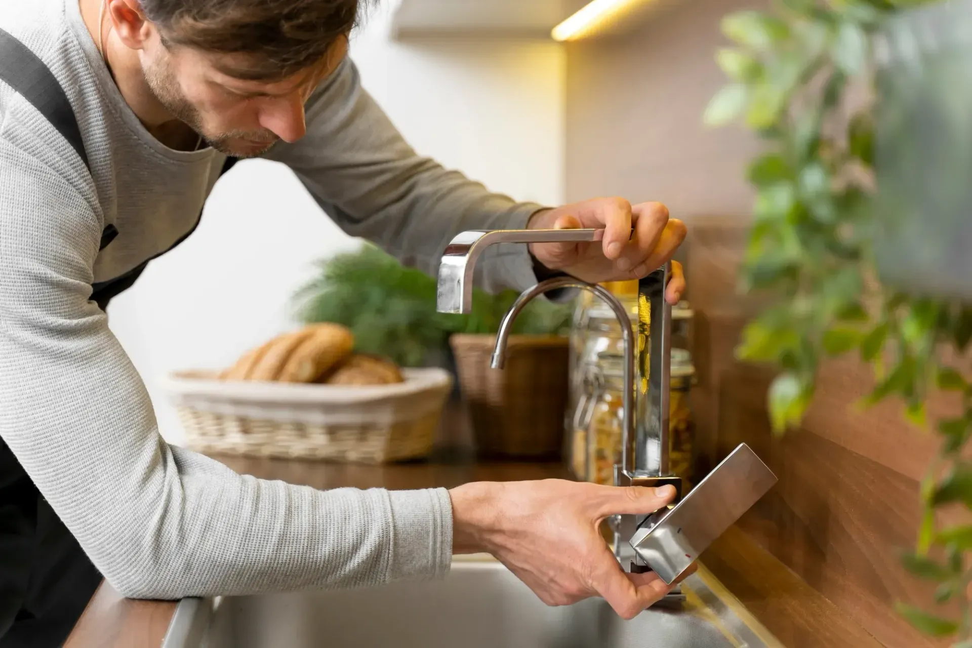 A person installing a water filter