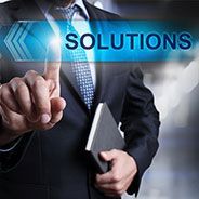 a man in a suit and tie is holding a book and pressing a button that says `` solutions '' .