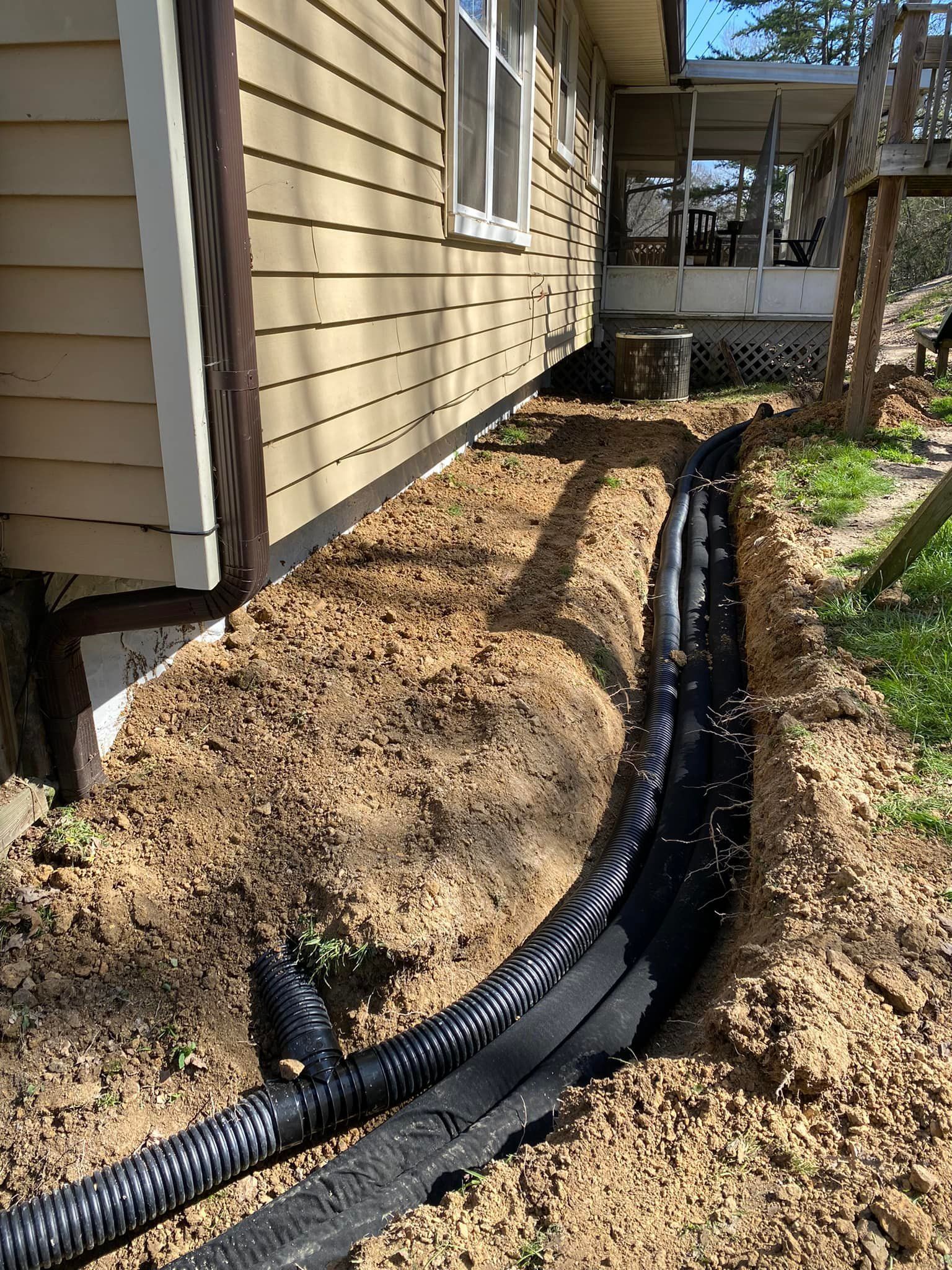 a drainage system is being installed on the side of a house .