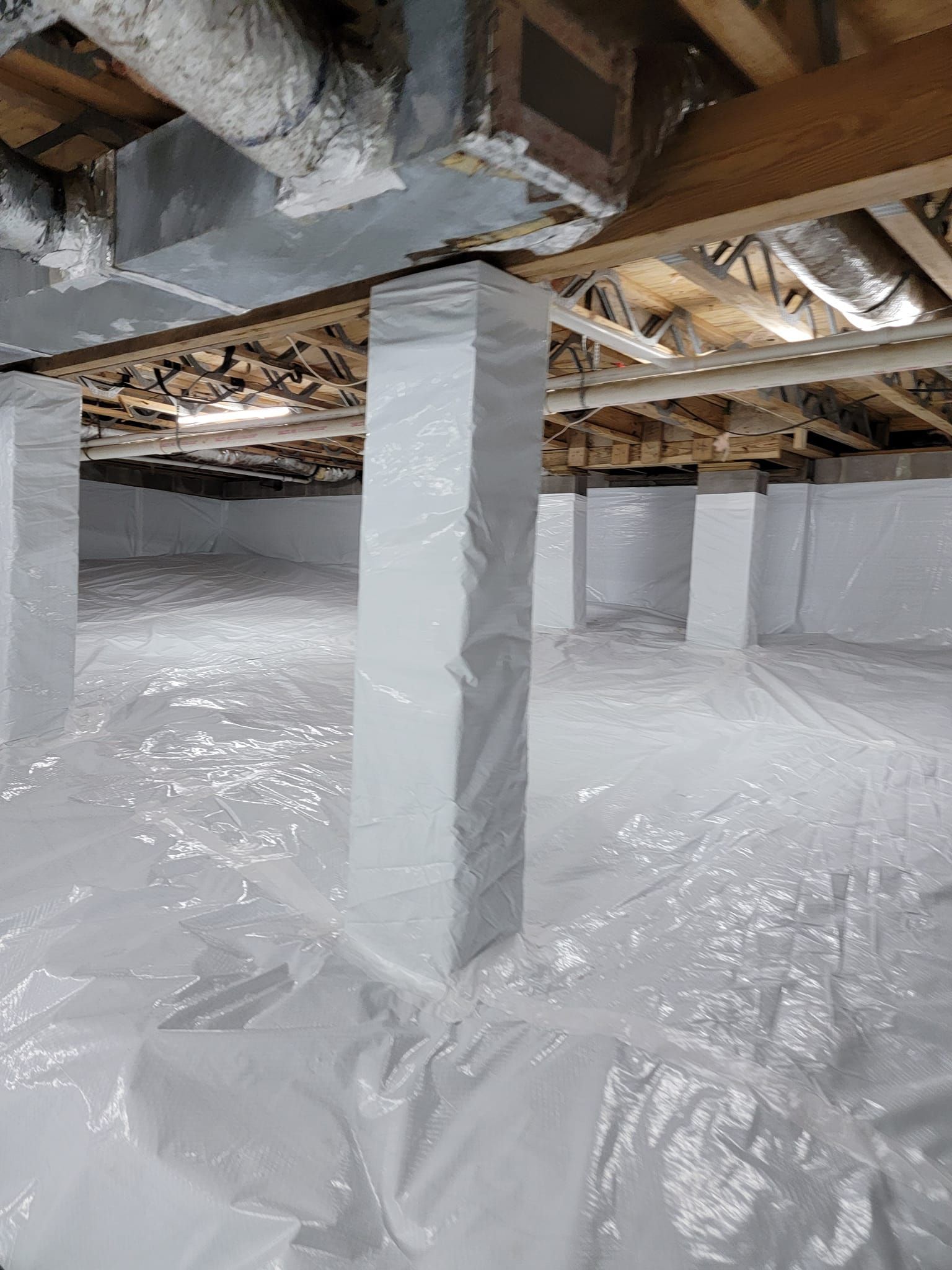 the foundation of a house is covered in plastic .