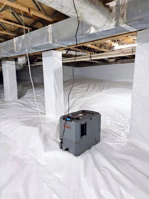 a machine is sitting in a basement covered in plastic .