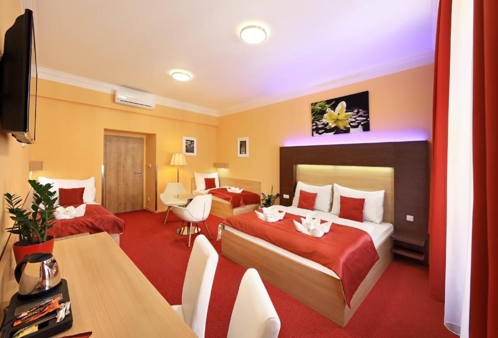 A hotel room with a king size bed and two twin beds