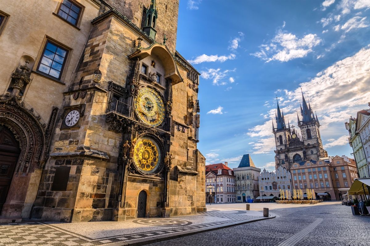 A clock tower in the middle of a city with a clock on the side of a building.
