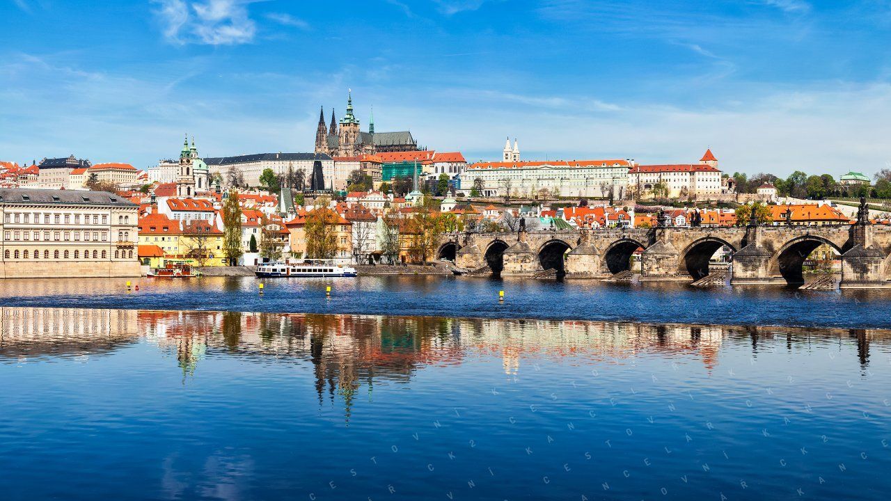A bridge over a river with a city in the background.