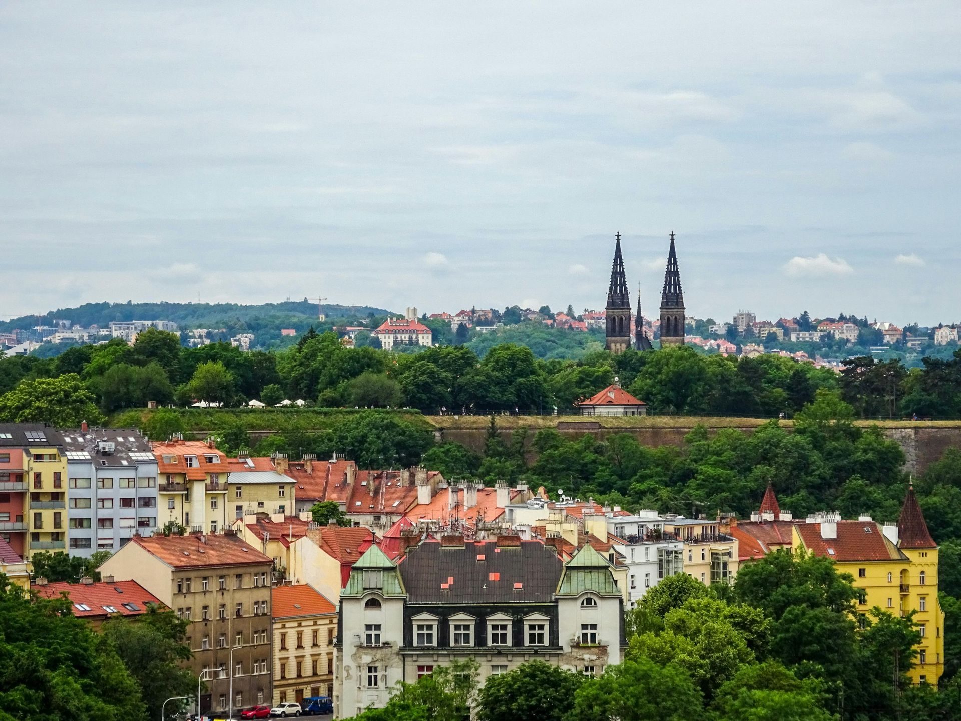 An aerial view of a city with a castle in the background.
