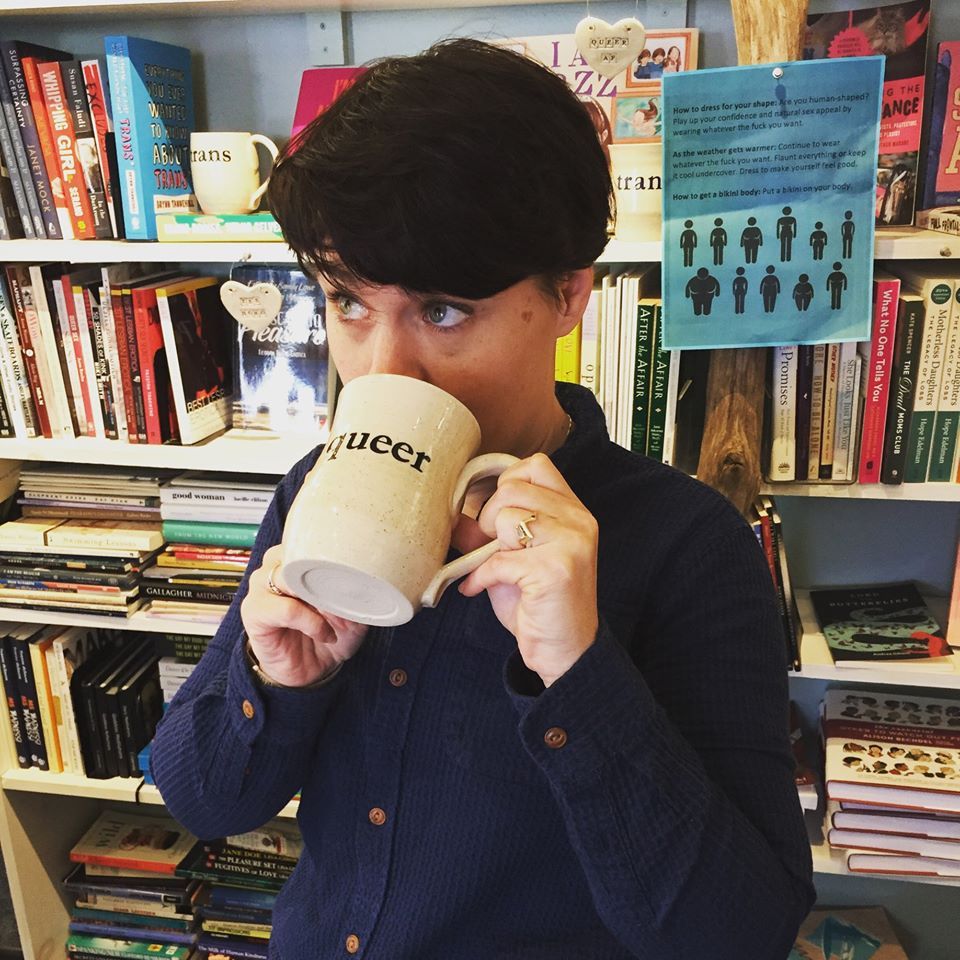 Rachel Spangler drinking coffee out of queer mug