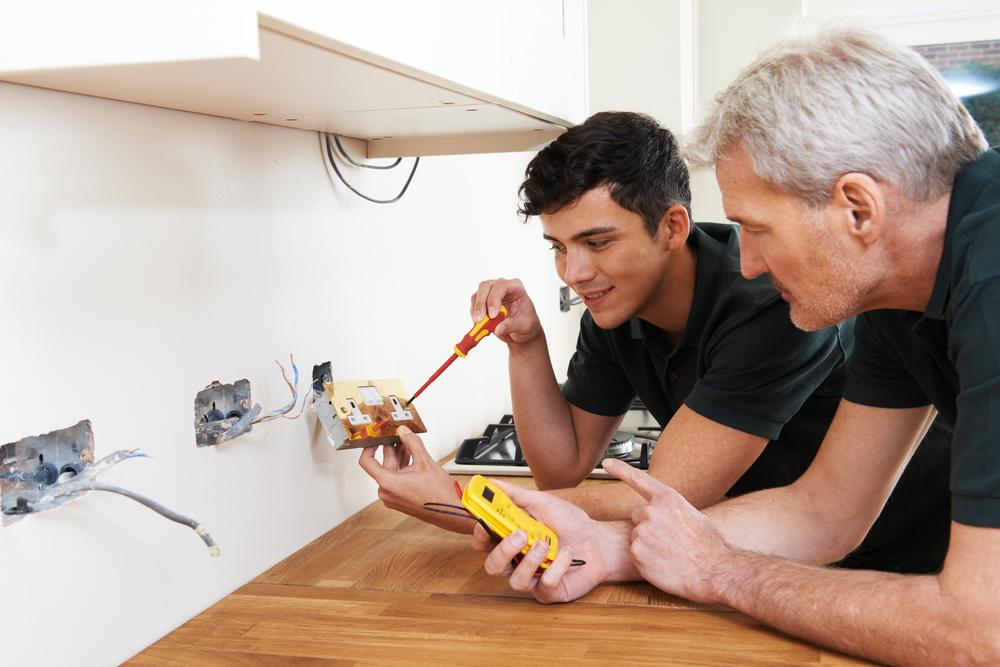 Electricians Repairing Home Outlets — Electrical Services in Renwick, NSW